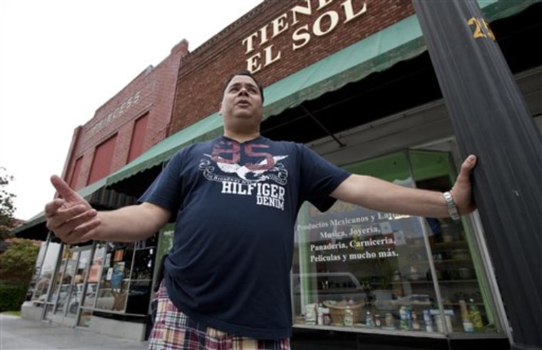 Jose Contreras stands outside his closed store and restaurant in Albertville, Ala., Wednesday, Oct. 12, 2011. Dozens of businesses across the state shut down as Hispanics took a day off from work to protest against Alabama's tough new immigration law. (AP Photo/Dave Martin)